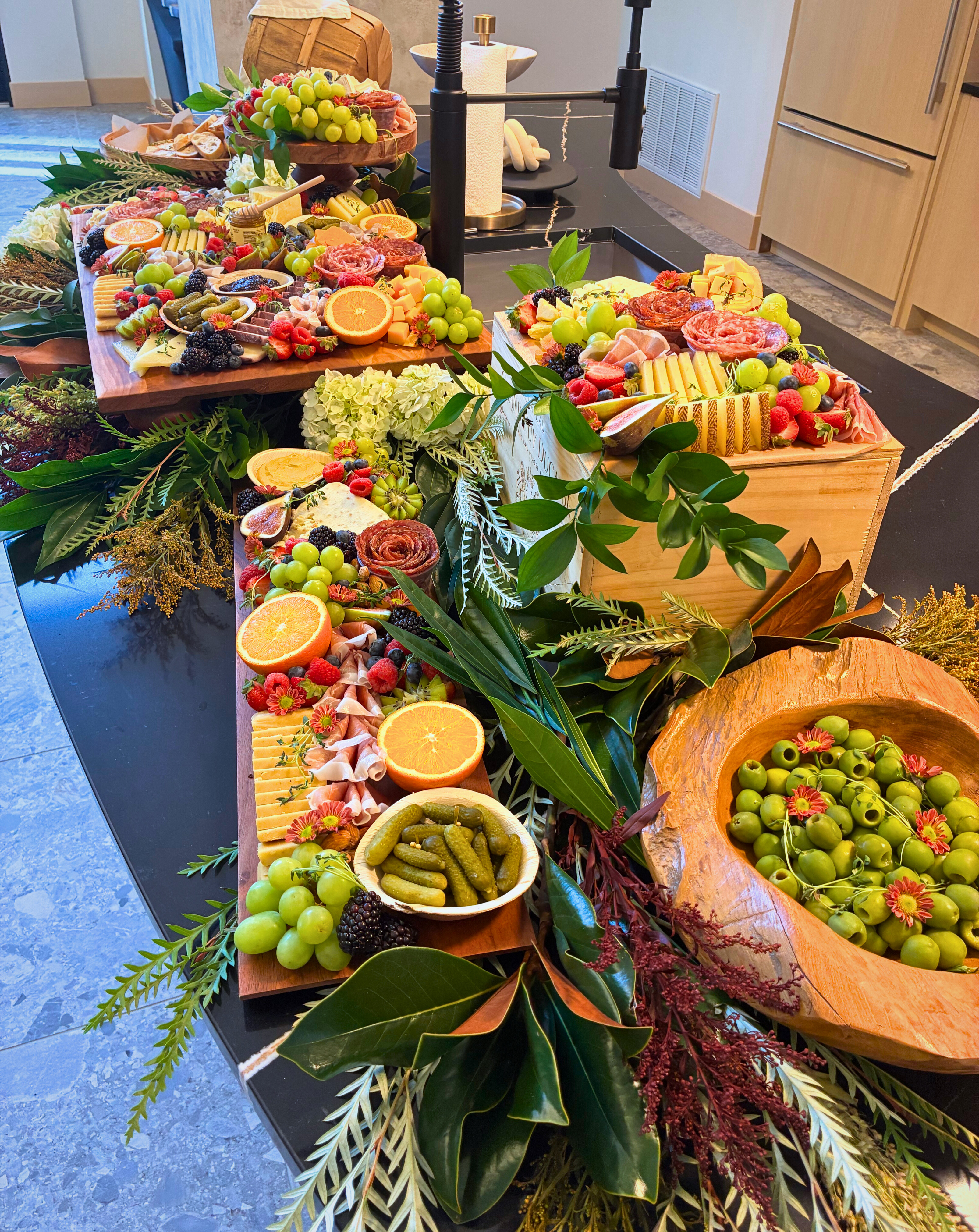 A festive holiday grazing table filled with artisanal cheeses, charcuterie, fresh fruit, and elegant seasonal garnishes by CharcuterieBrie, a luxury grazing table caterer serving Chicago and the western suburbs.