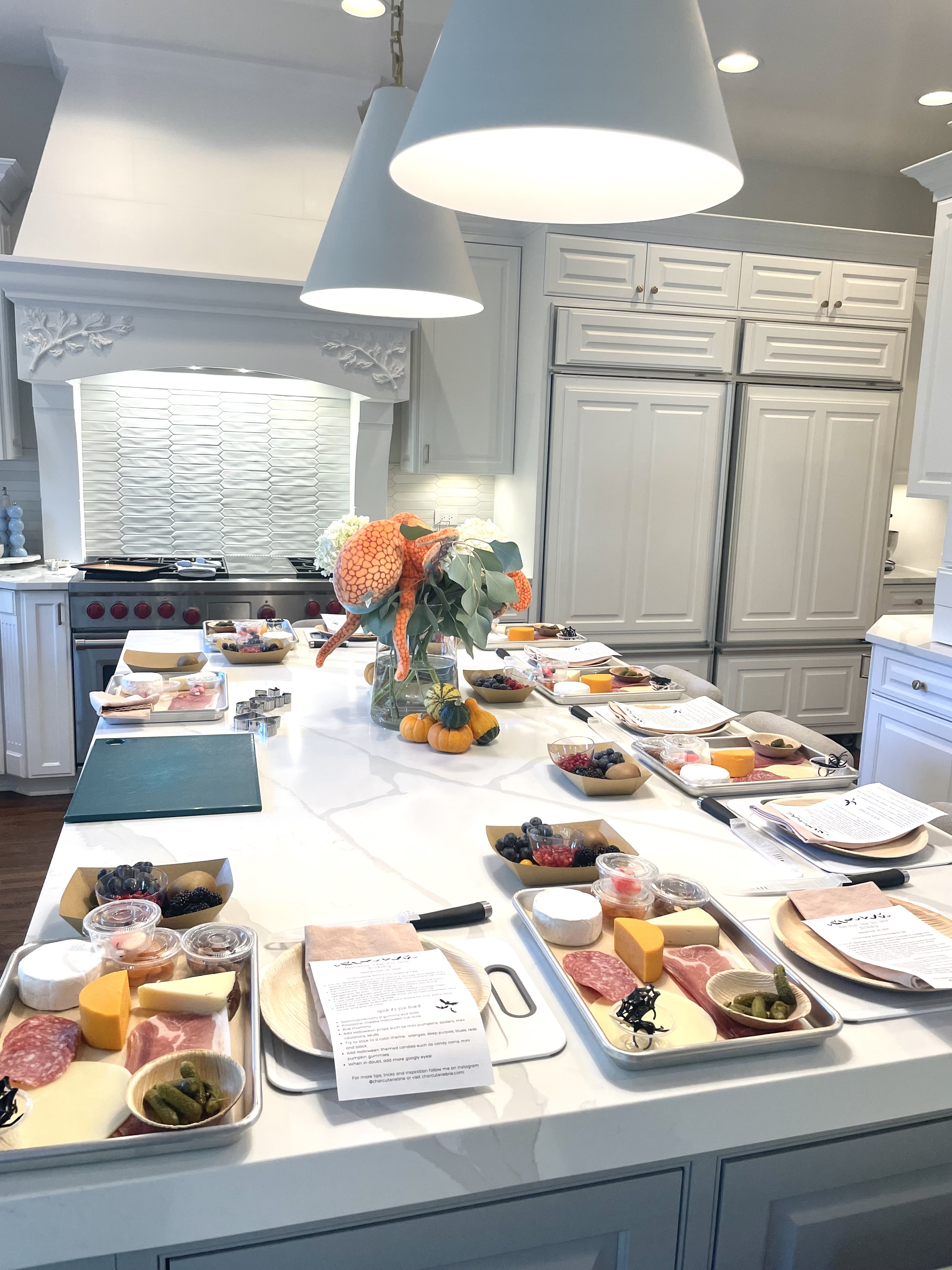 Charcuterie workshop in Chicago with guests learning to style artisan cheeses, charcuterie, and seasonal accompaniments