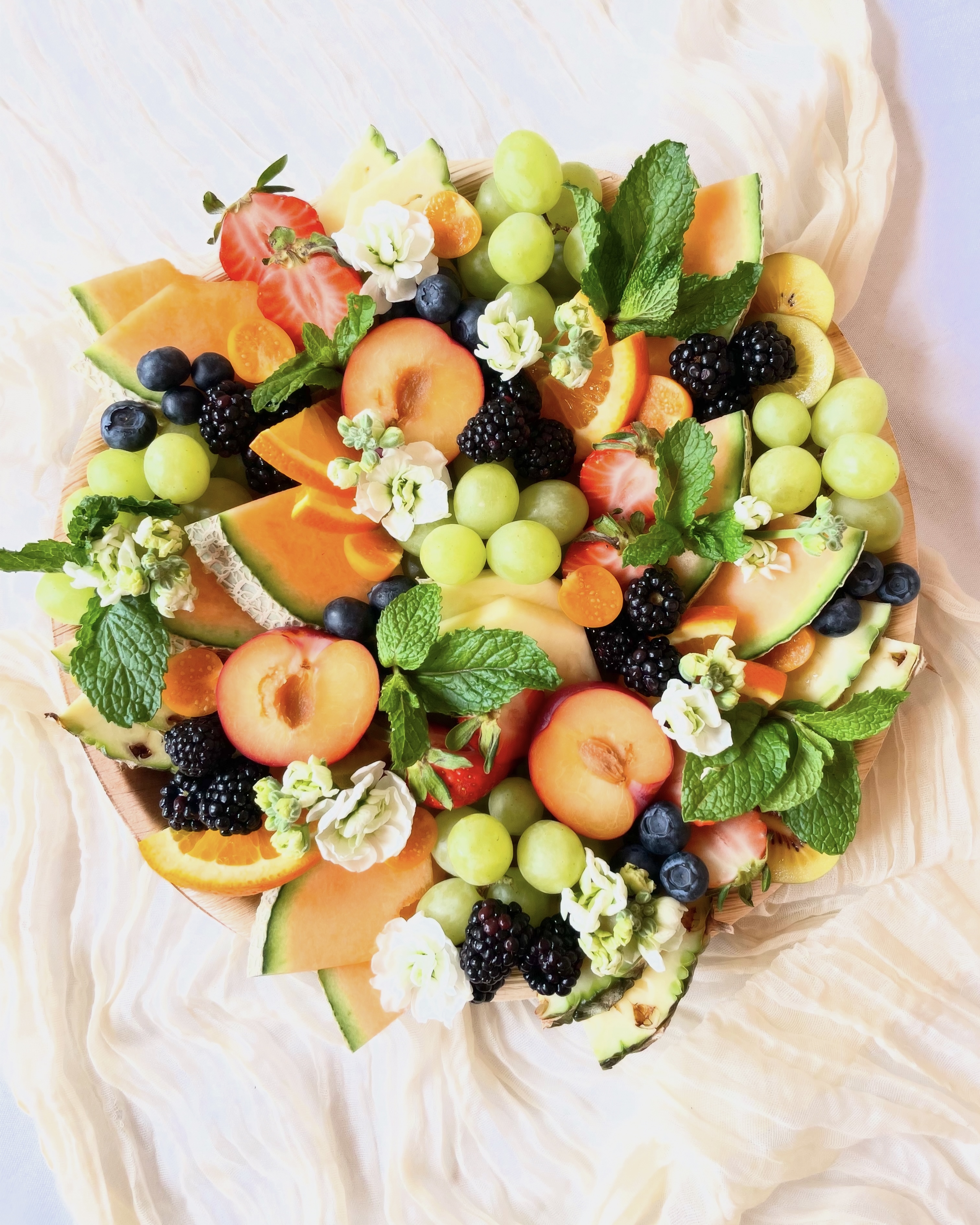 Elegant fruit board featuring a colorful selection of fresh, seasonal fruit, thoughtfully styled for entertaining.