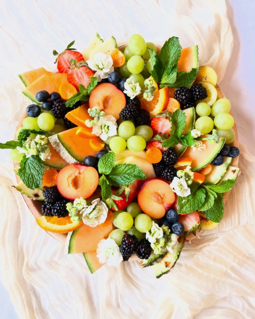 Seasonal fruit board styled with florals and greenery, ideal for celebrations in Oak Park, Burr Ridge, and nearby suburbs