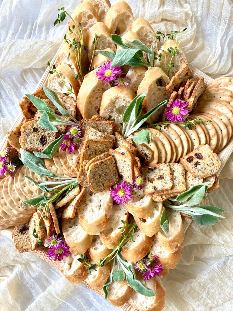 Elegant large baguette and cracker board with artisan breads, styled with greenery for events in Oak Brook and Riverside.