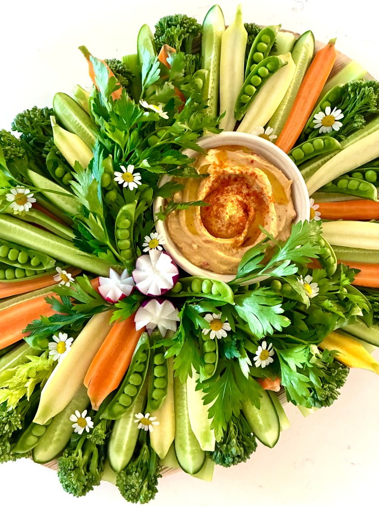 Vibrant crudité board with seasonal vegetables, dips, and fresh florals, perfect for entertaining in Hinsdale and River Forest