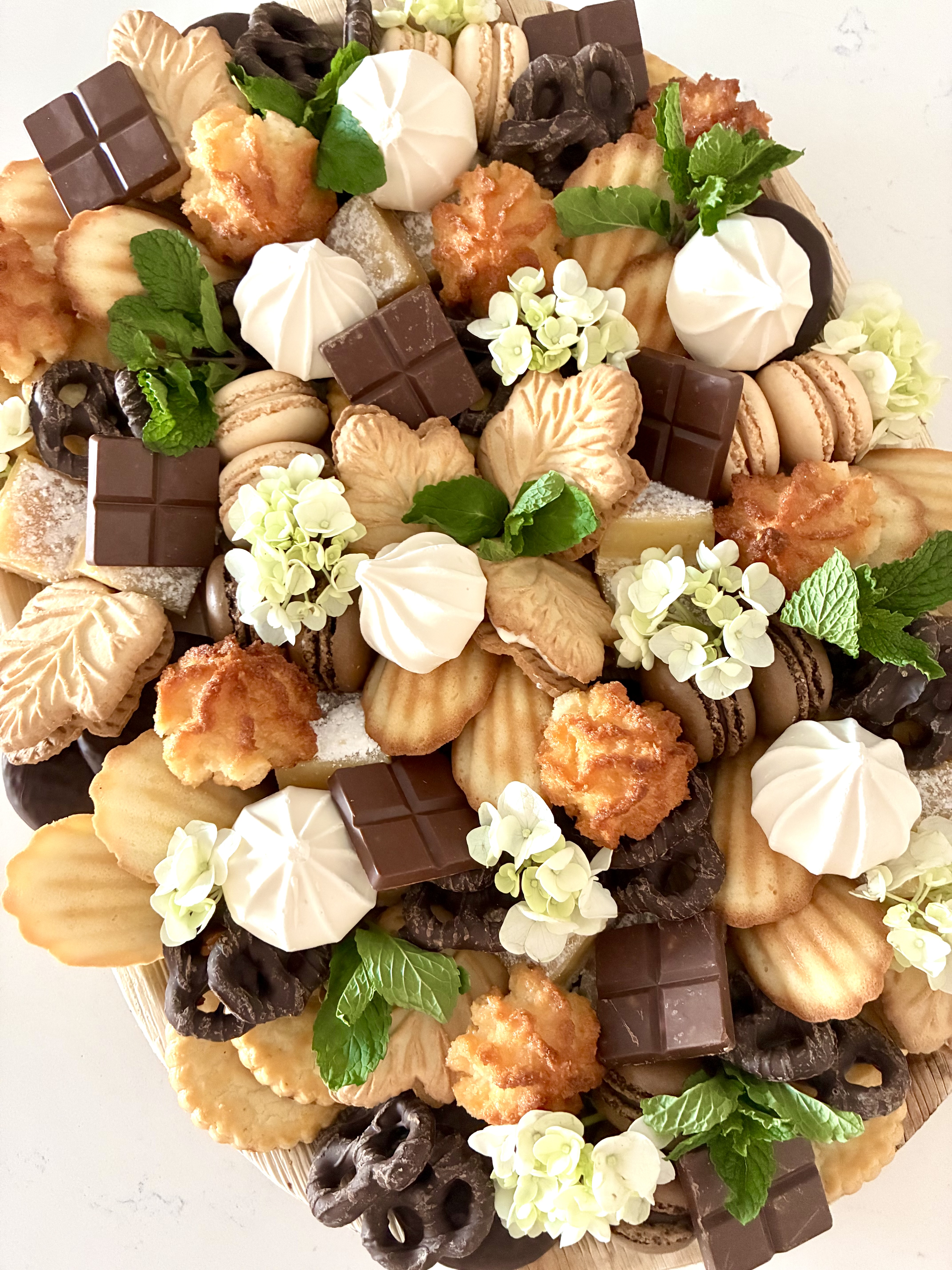Luxury dessert board in Chicago with cookies, macarons, lemon bars, chocolates, and assorted sweets, arranged for gatherings and events